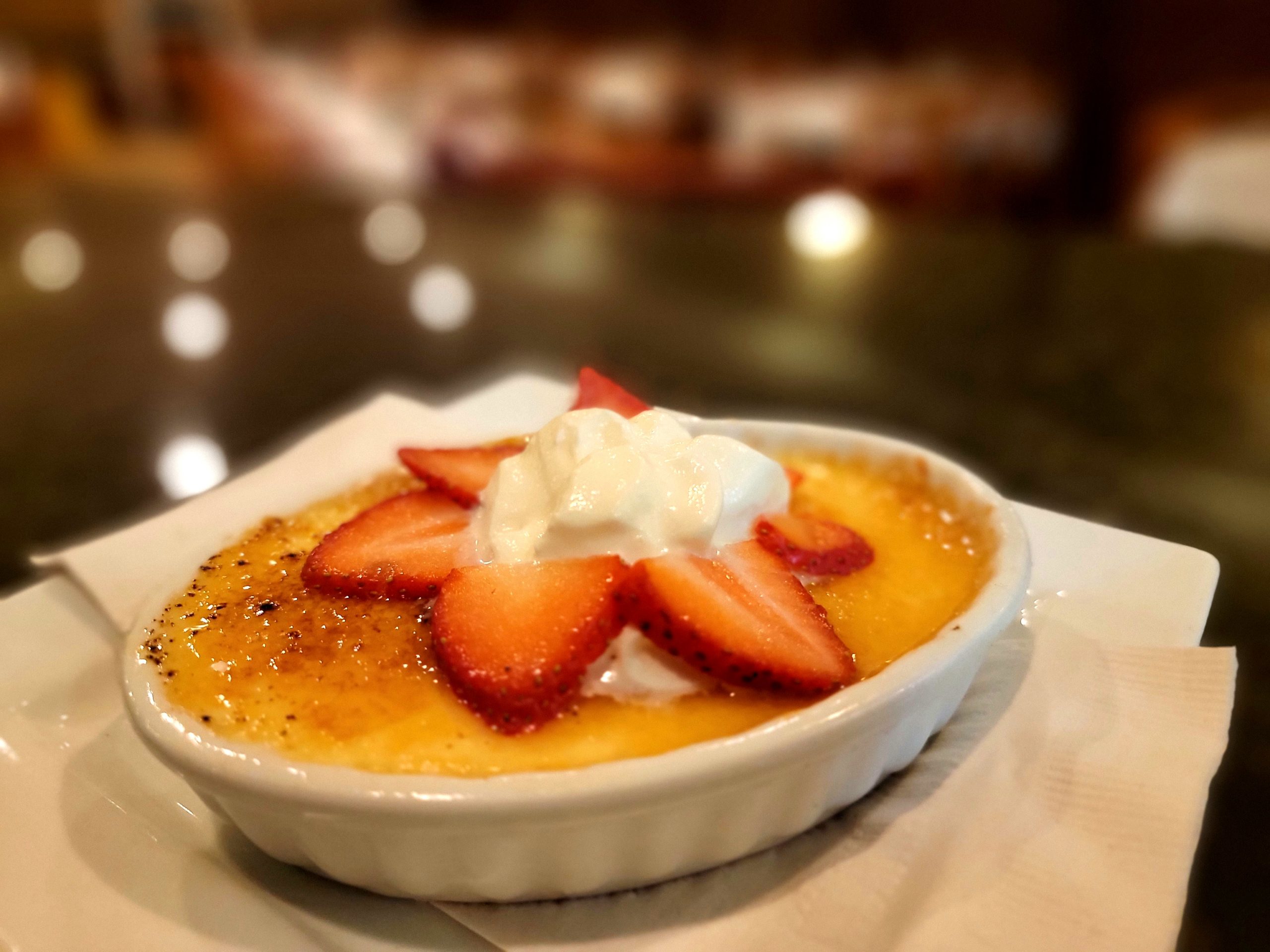 Crème brûlée topped with fresh strawberries