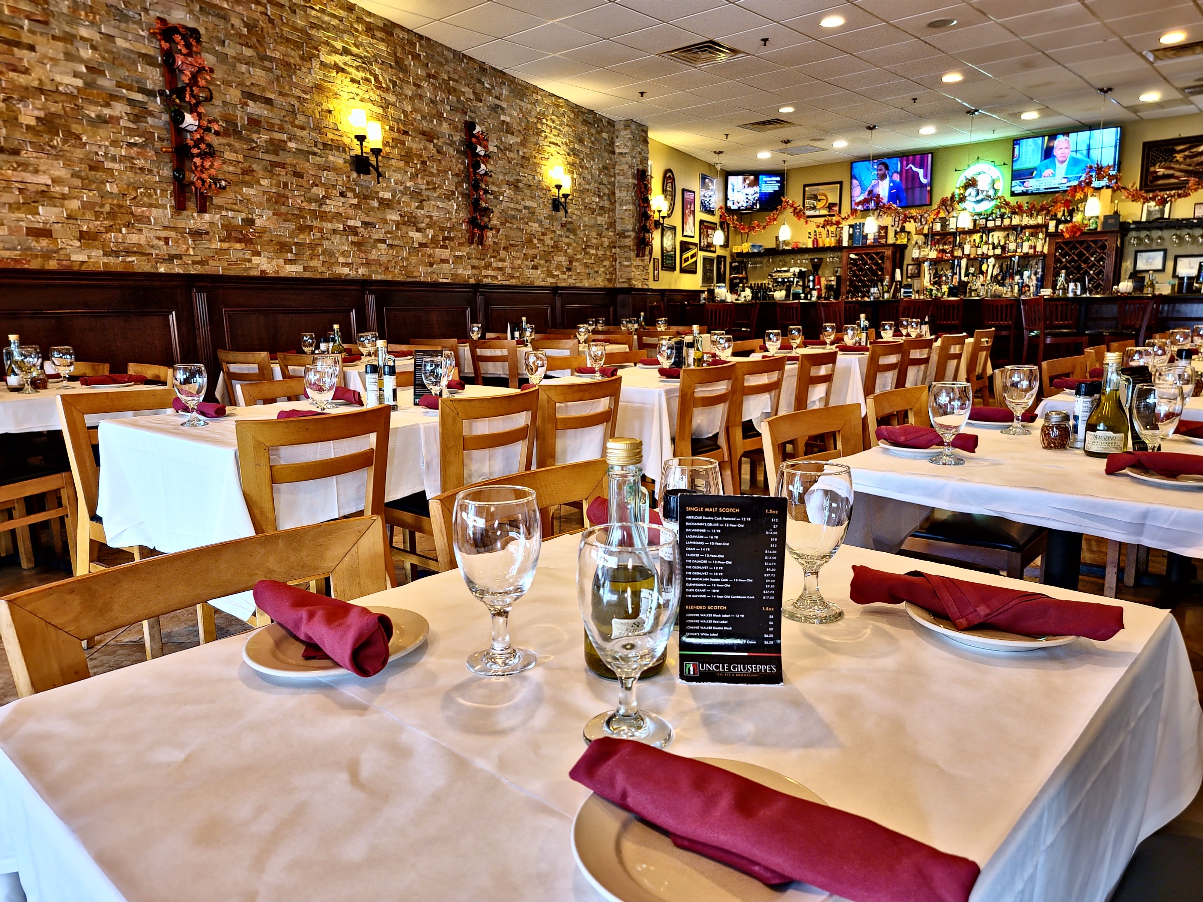 The dining room with stone walls and white-clothed tables