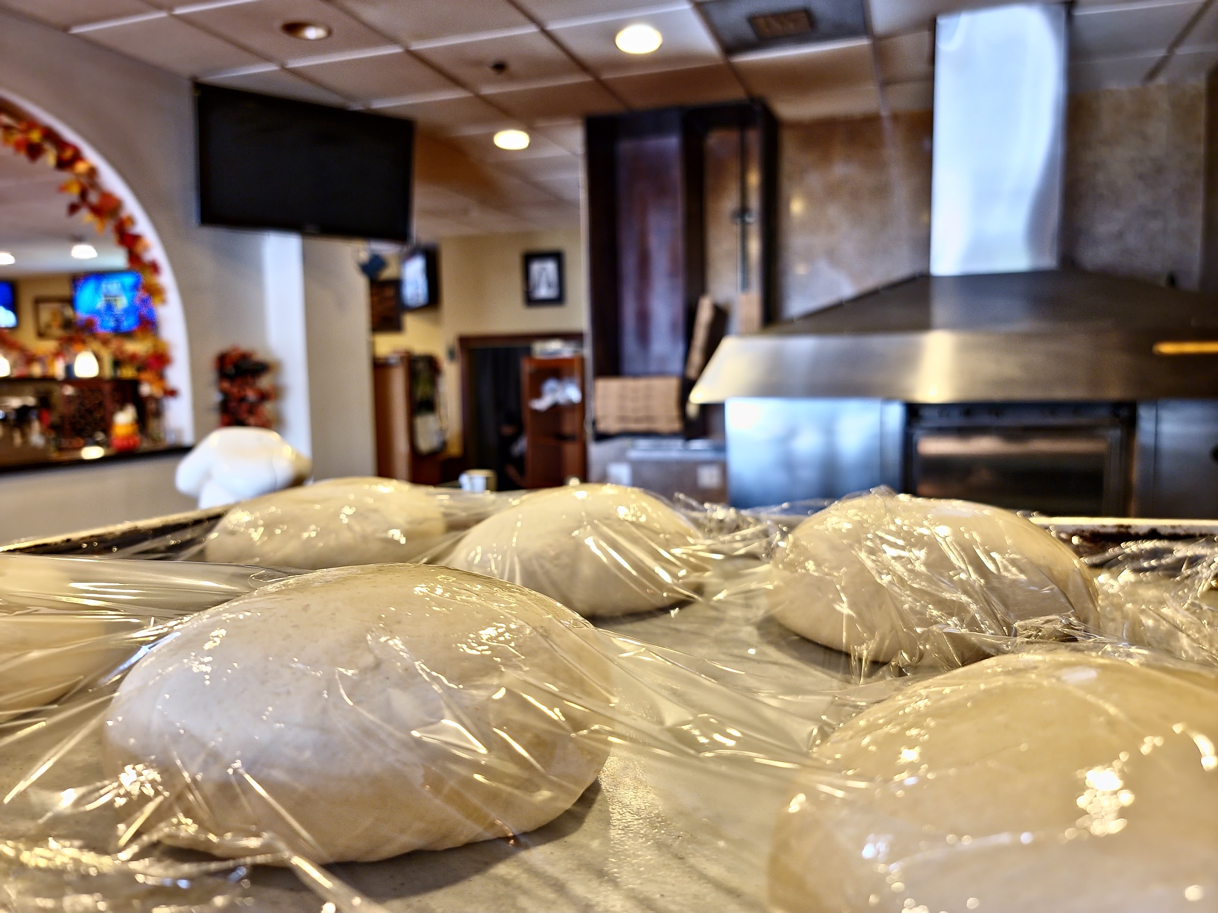 Hand-stretched pizza dough at the bench