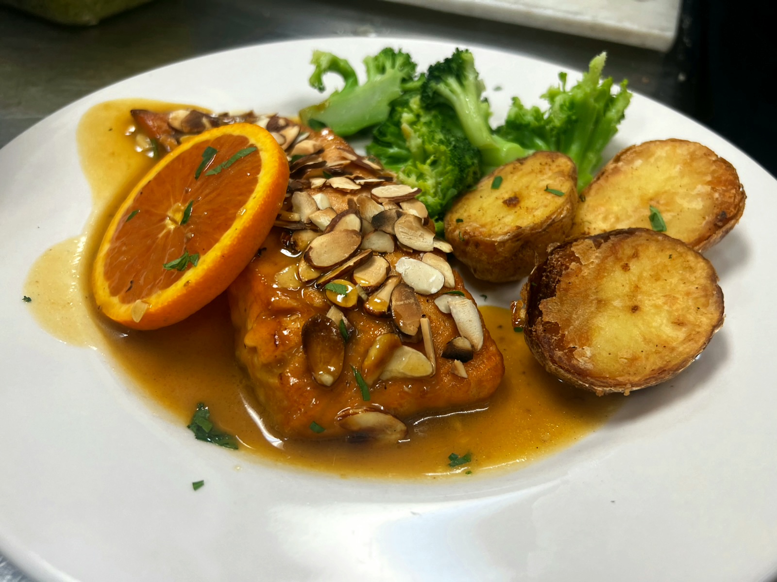 Salmon almondine with broccoli and roasted potatoes