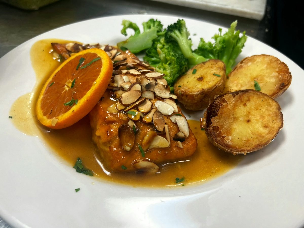 Salmon almondine with sliced almonds, broccoli and roasted potatoes